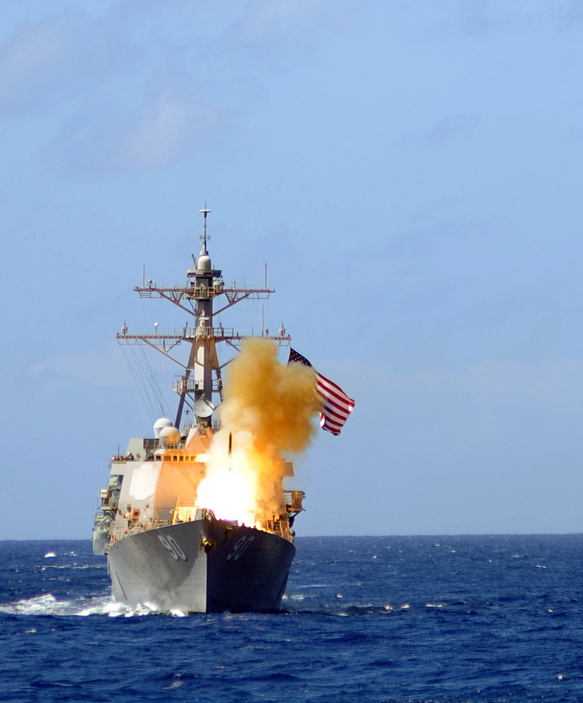 Navy destroyer sailing under the national flag